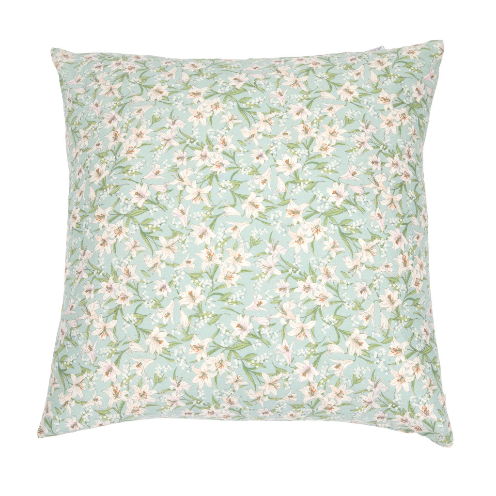 A square throw pillow featuring a delicate floral print with white blossoms and green leaves on a soft mint green background, isolated on a white studio background.