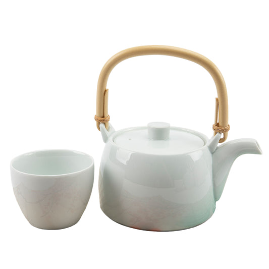White teacup and teapot on a white background.
