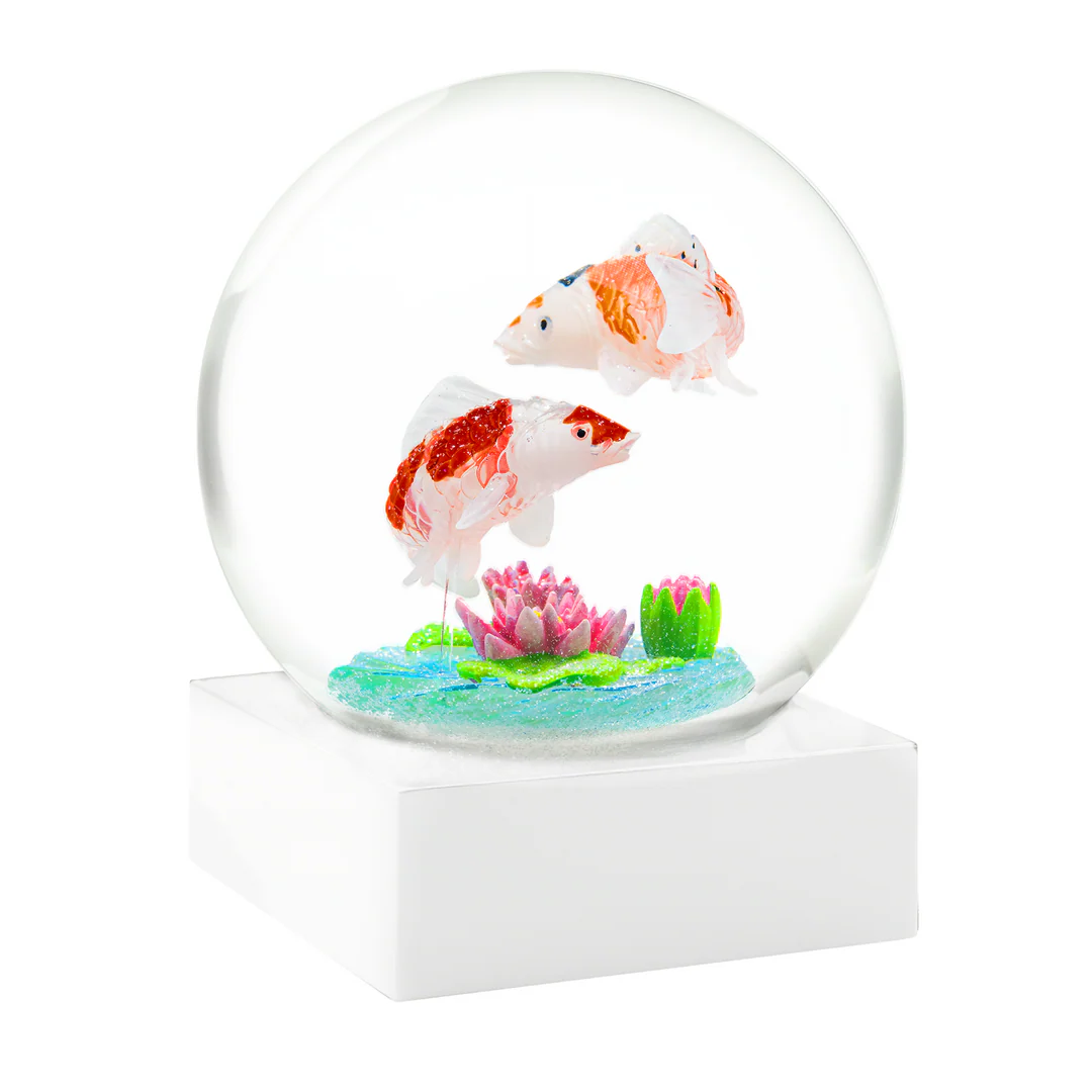 Glowing snow globe with two goldfish and a lily pad on a white background