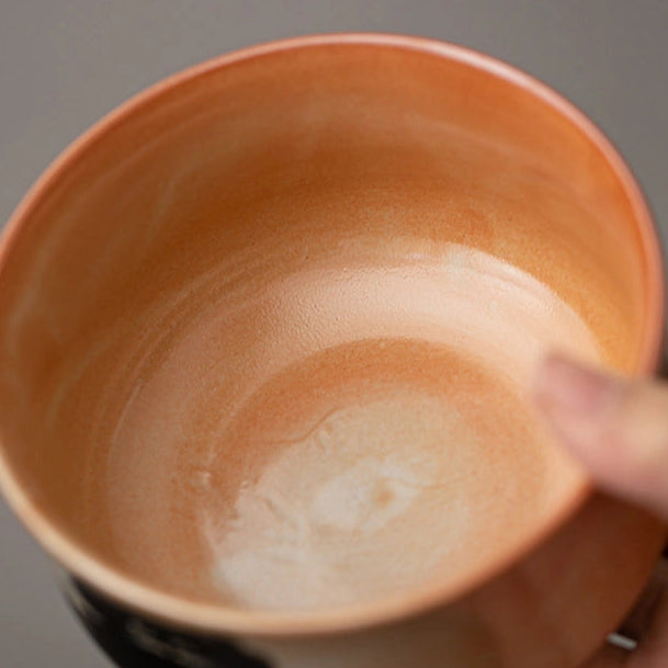 Hand holding a ceramic bowl with a swirling pattern