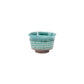 Green ceramic cup on a white background