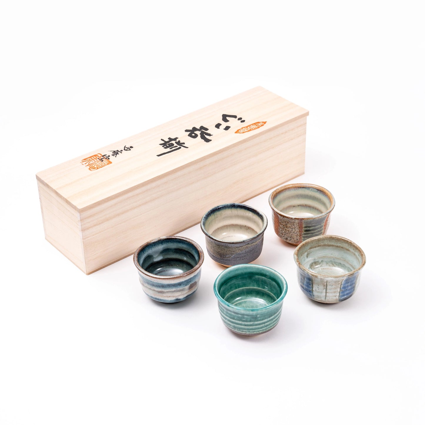 Set of six ceramic cups with a wooden box on a white background