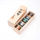 Set of sake set cups in a wooden box on a white background