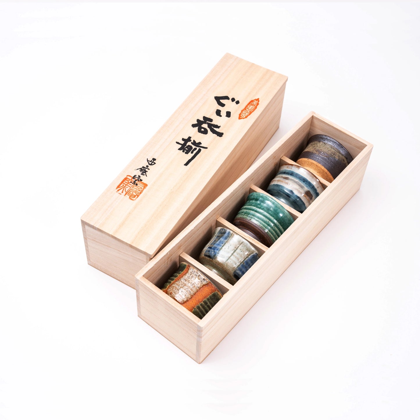 Set of sake set cups in a wooden box on a white background