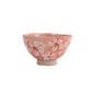 Small ceramic bowl with cherry blossom design on a white background