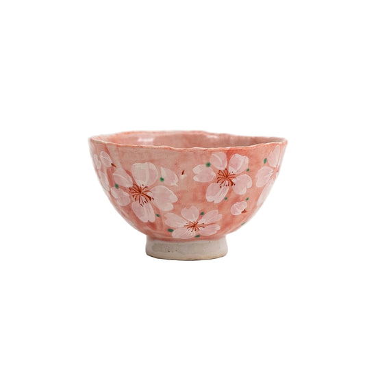 Small ceramic bowl with cherry blossom design on a white background