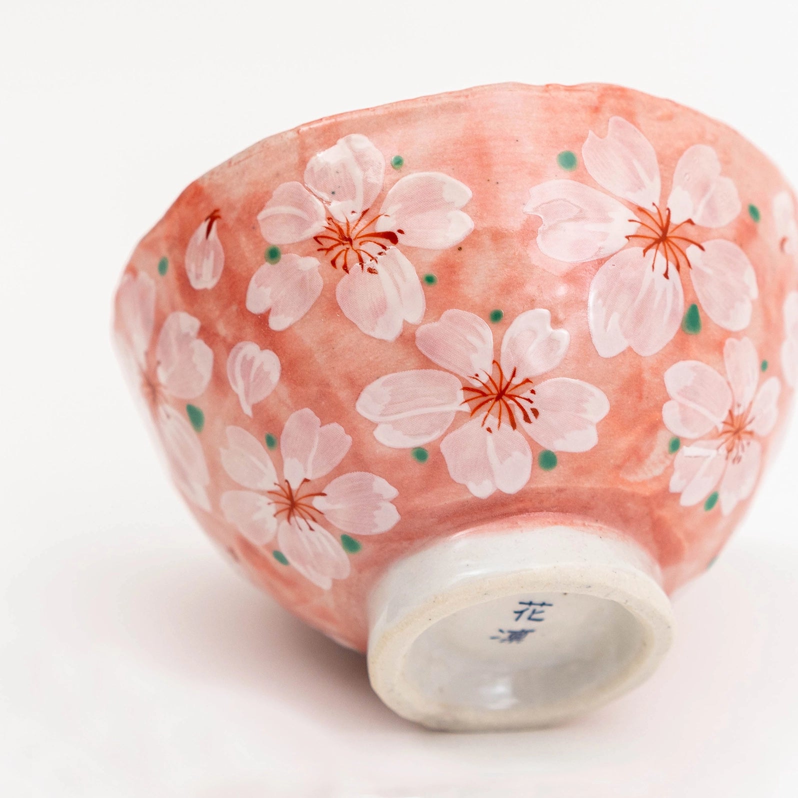 Ceramic bowl with cherry blossom design on a white background