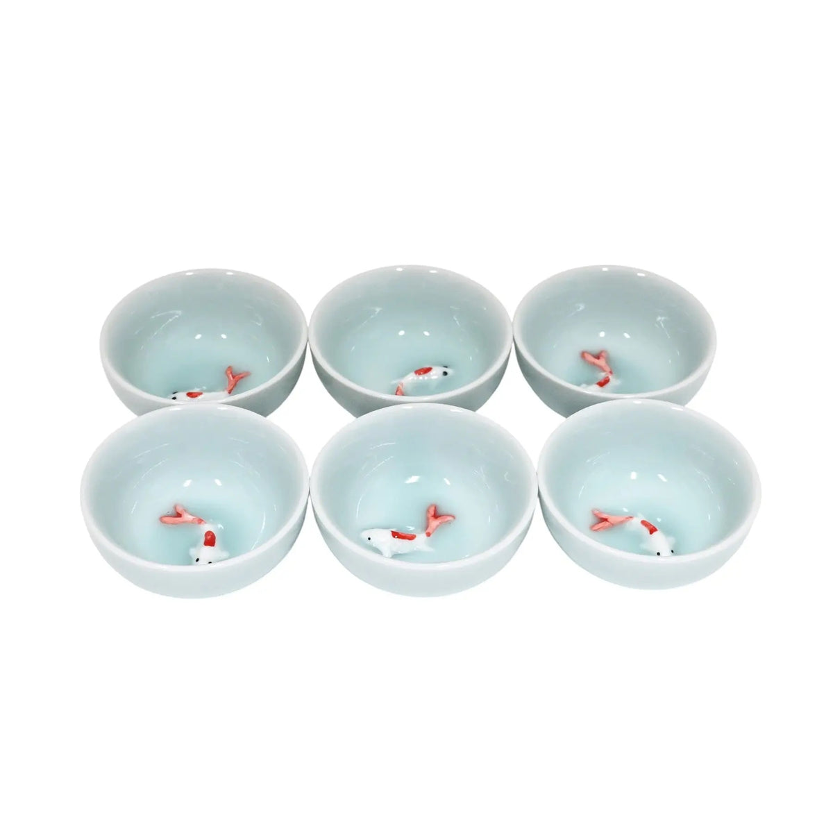 Set of six small ceramic bowls with fish design on a white background