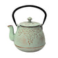 Light green ceramic teapot with black handle on a white background