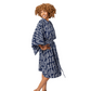 A woman modeling a navy blue and white patterned bathrobe against a plain white studio background.